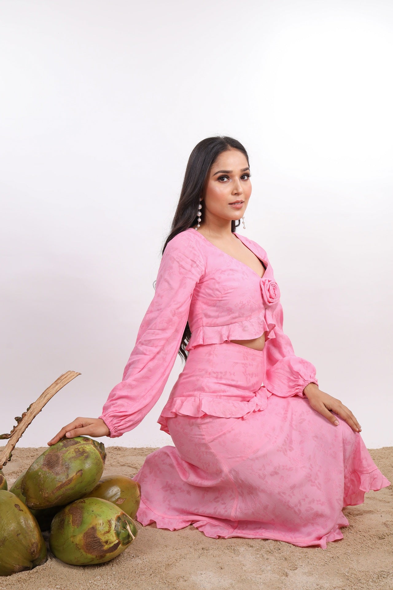 Pink Amelia Skirt – effortlessly chic resort wear for women, featuring flattering midi length, diagonal ruffles, hem frill, and side zipper. Lined with soft cotton cambric for comfort. Perfect for beach vacations, sunset dinners, and summer getaways.