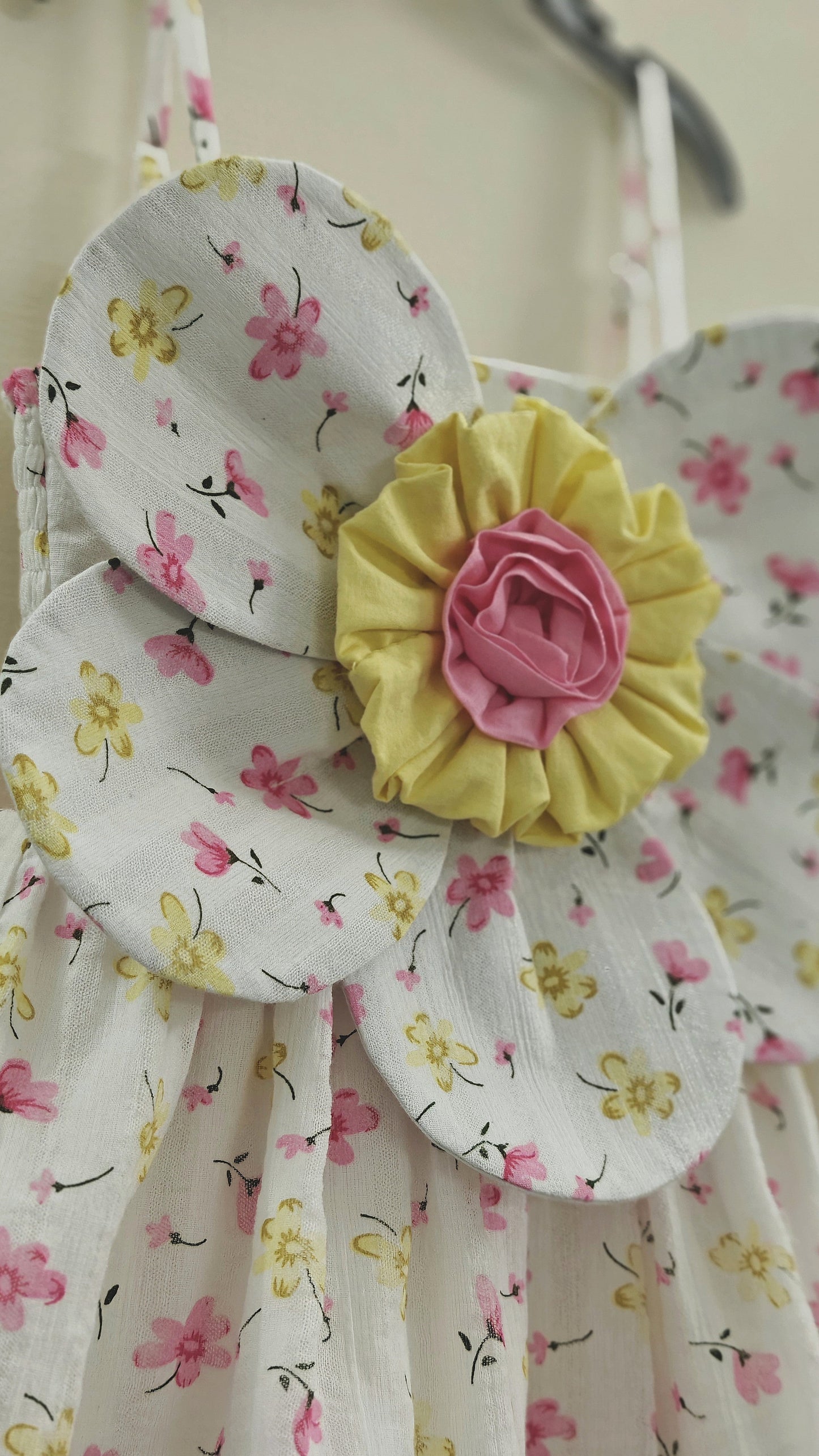 close up of the big 3d floral detail on the baby girl summer dress.
