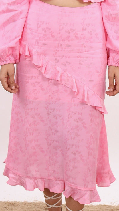 Pink Amelia Skirt – effortlessly chic resort wear for women, featuring flattering midi length, diagonal ruffles, hem frill, and side zipper. Made in soft viscose jacquard - floral pattern fabric, Lined with soft cotton cambric for comfort. Perfect for beach vacations, sunset dinners, and summer getaways.