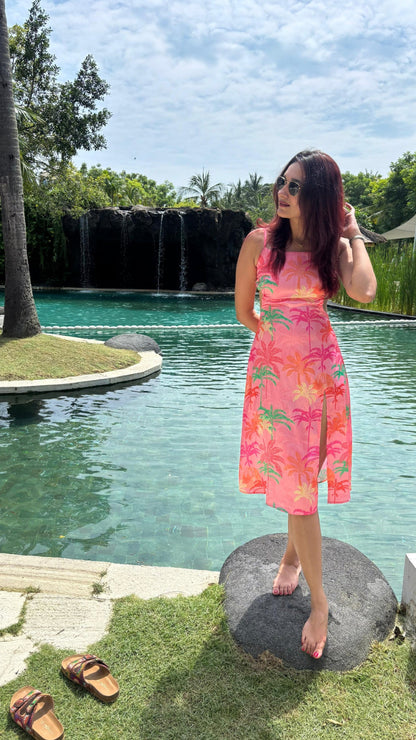 WOMEN IN TROPICAL SATIN PRINTED DRESS, STANDING POOL SIDE ON HER VACATION. TRENDING SUMMER DRESS BY SOLIESSE.