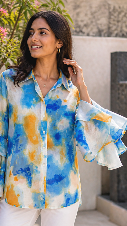 CLOSE UP OF THE TIE DYE SHIRT HAND MOVEMENT OF SLEEVE.